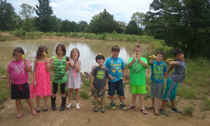 Nine of the Elementary Summer School students pose at the Outdoor Learning Center.